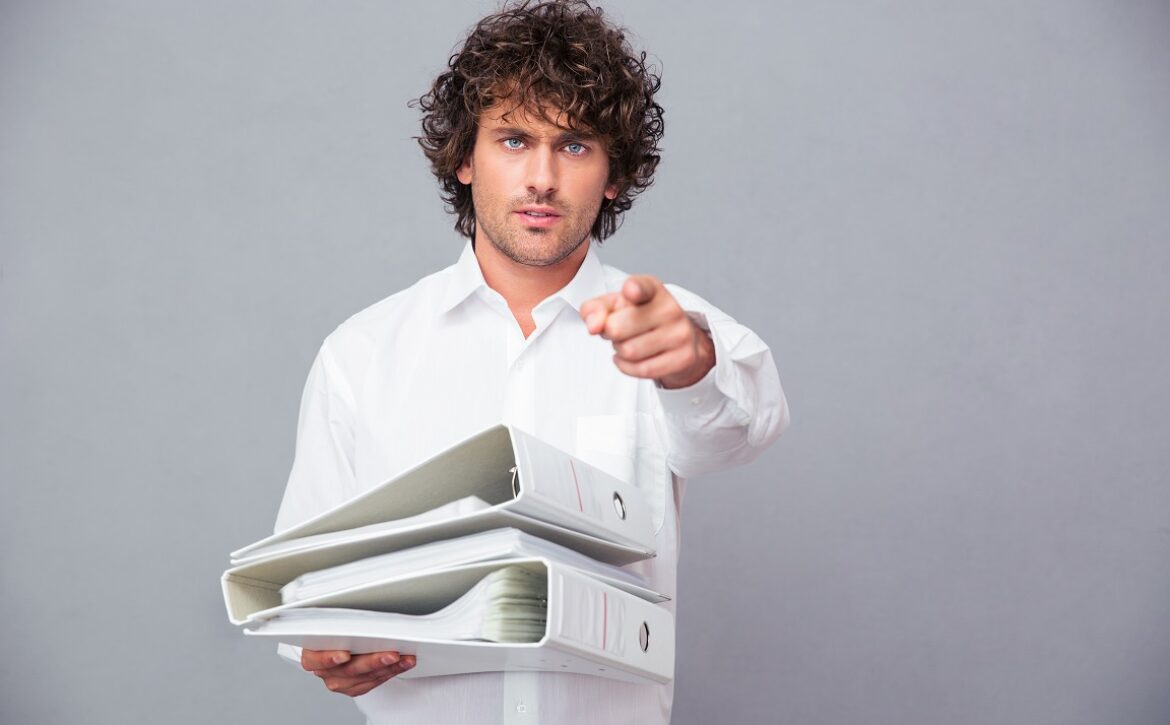 Businessman pointing finger at camera