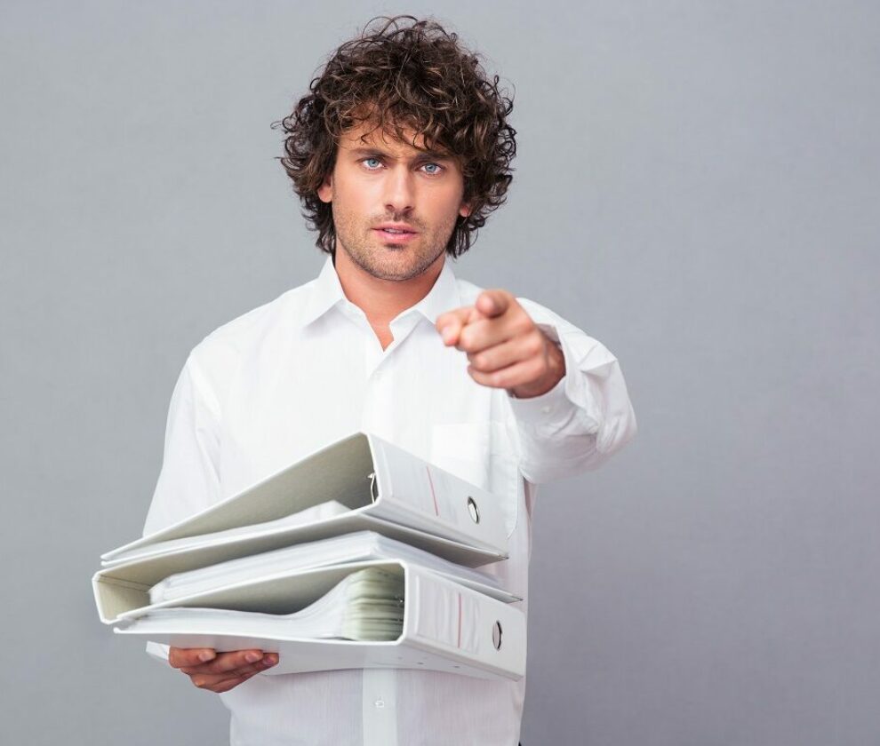 Businessman pointing finger at camera